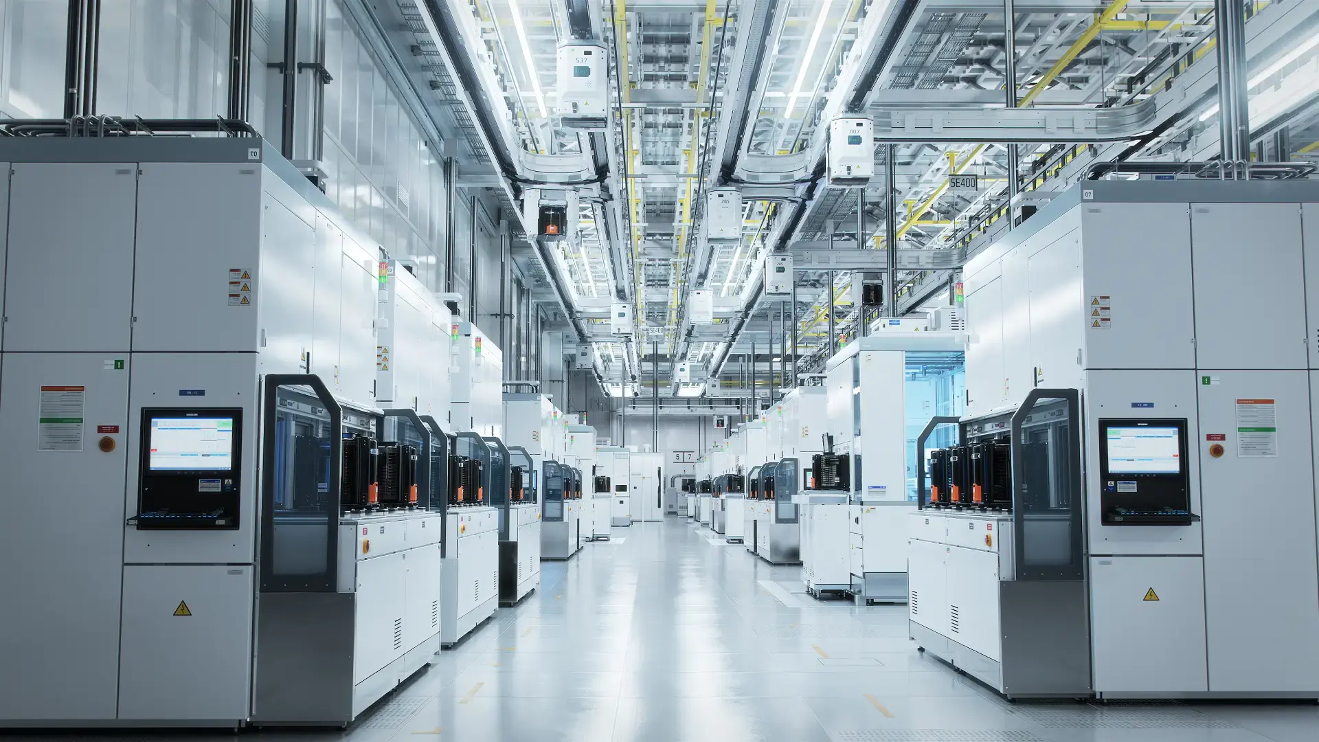 Modern semiconductor manufacturing cleanroom with automated machines, wafer processing equipment, and overhead Automated Material Handling System (AMHS).